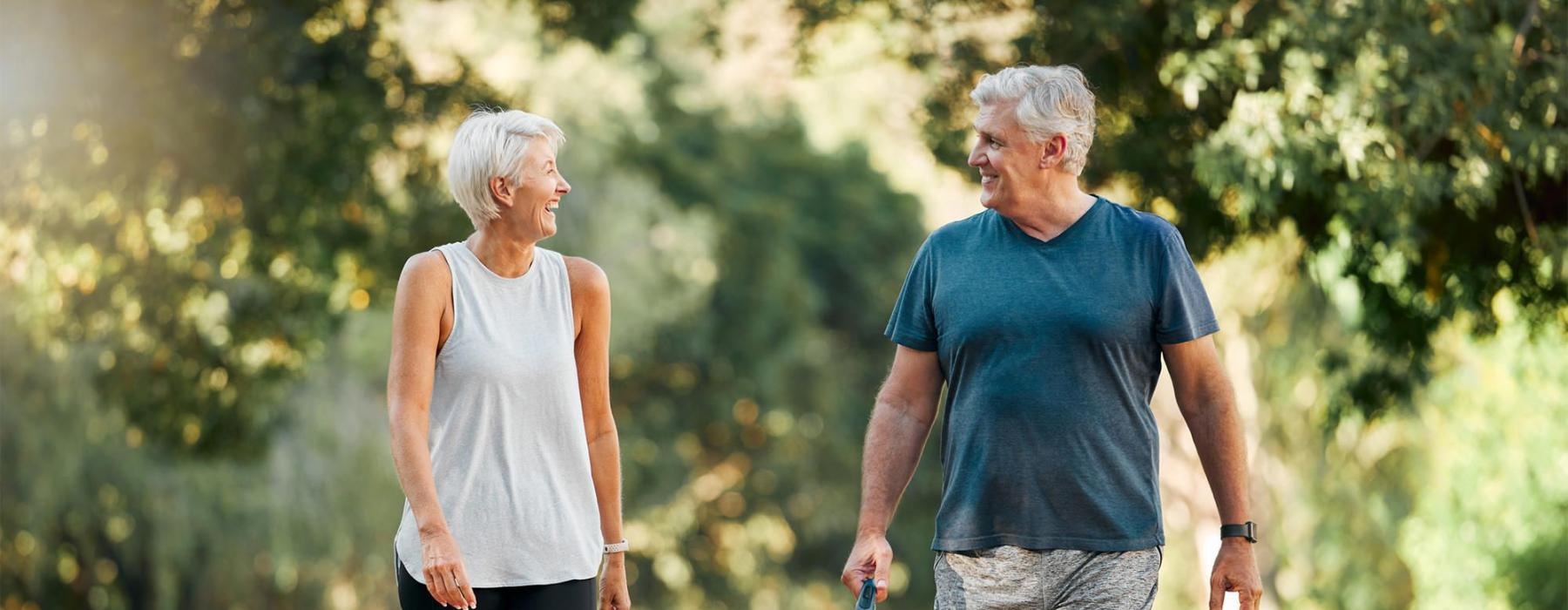 a man and a woman walking a dog on a leash